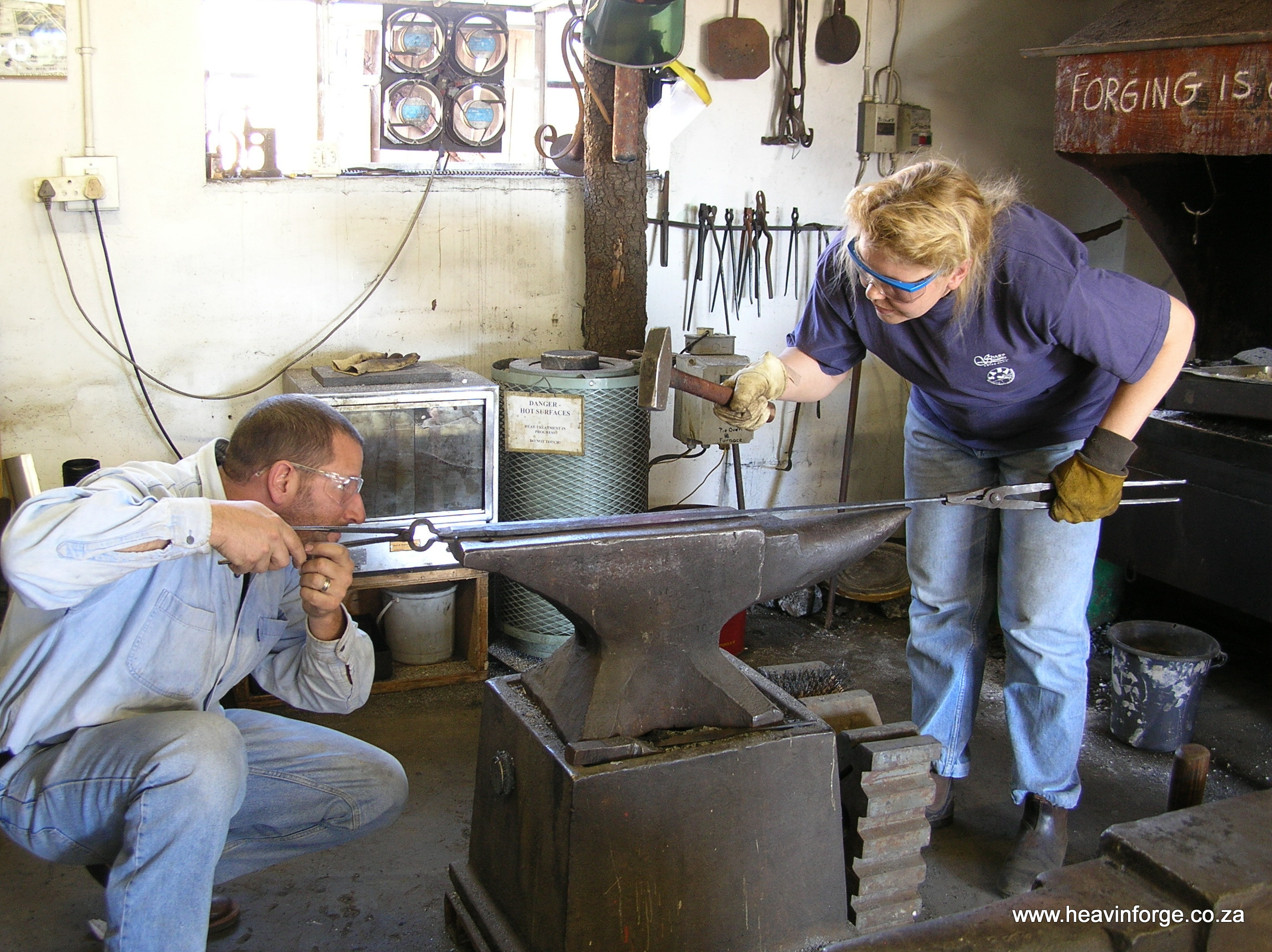 Kevin and Heather forging a damascus sword