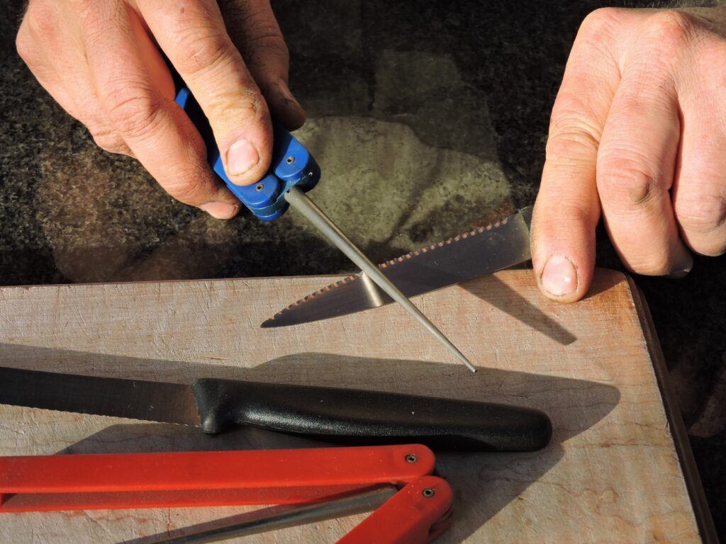 Photo of serrations being sharpened on a blade