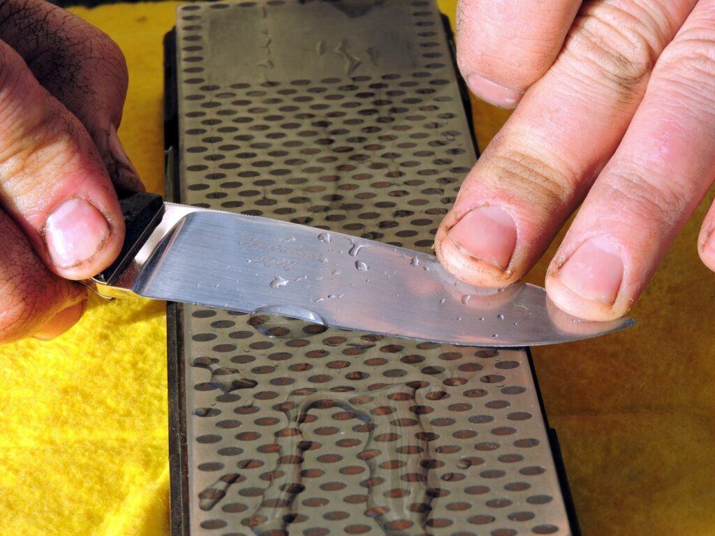 Photo of a knife being sharpened